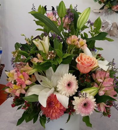 Always & Forever - A gorgeous container arrangement, created using the fresh blooms of the day in a mix of pale pink and white with complementary foliage.